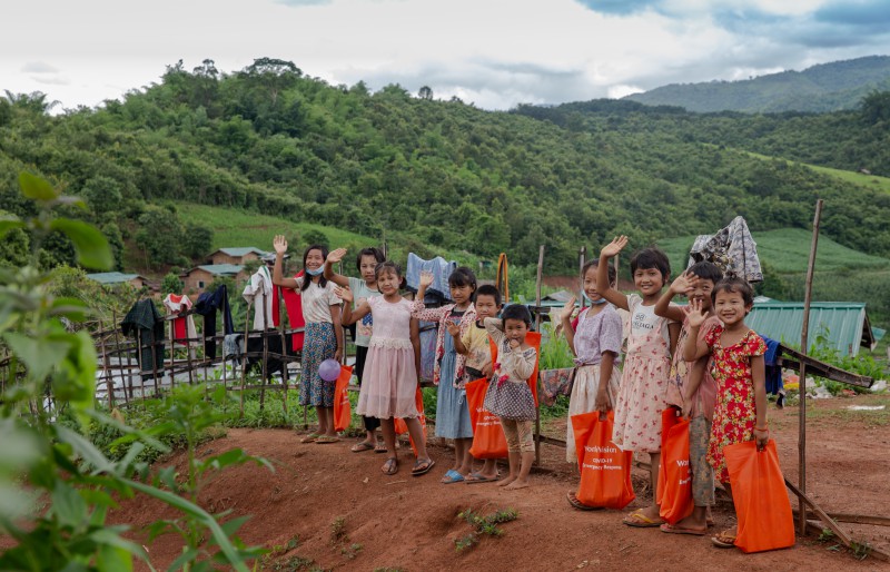 미얀마 아이들이 코로나19 예방용품, 교육자료를 전달받아 손을 흔들며 환한 미소를 짓고 있는 모습.